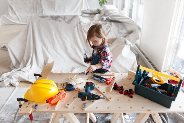 Litte 2 years old girl who dreams of becoming a carpenter