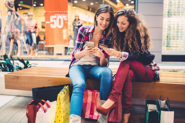 Smiling women shopping online with credit card