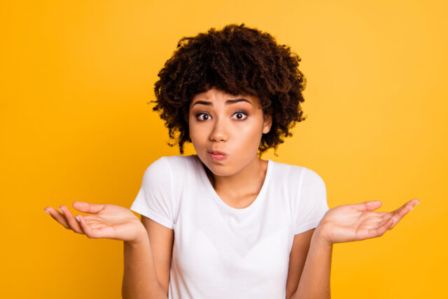 Close-up portrait of her she nice attractive puzzled ignorant wavy-haired girl showing gesture no information isolated on bright vivid shine yellow background.